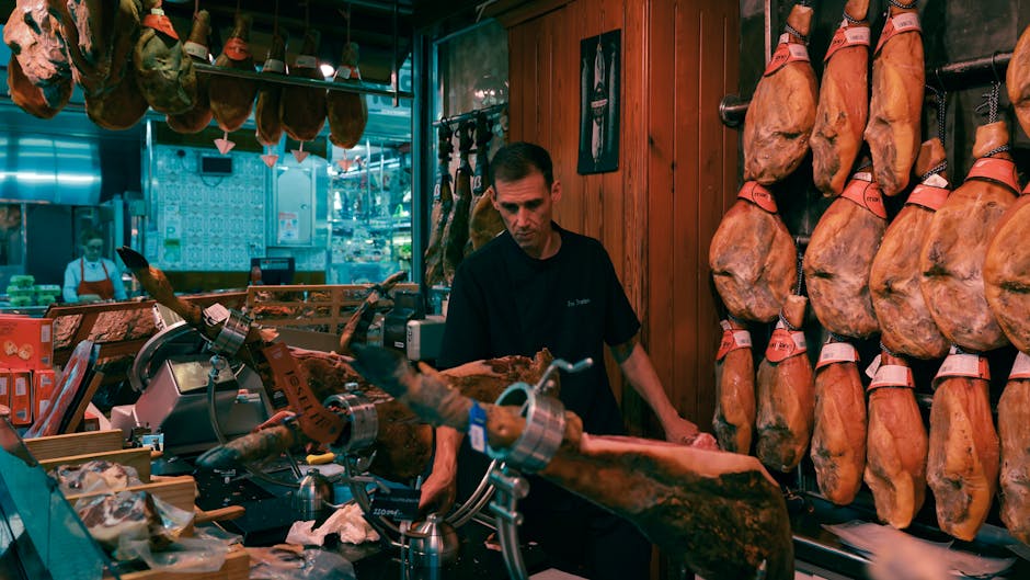 Jamón Ibérico Madrid Where to Buy: Best Shops 2026 3 A cortador slicing jamón ibérico by hand at a Madrid specialist shop