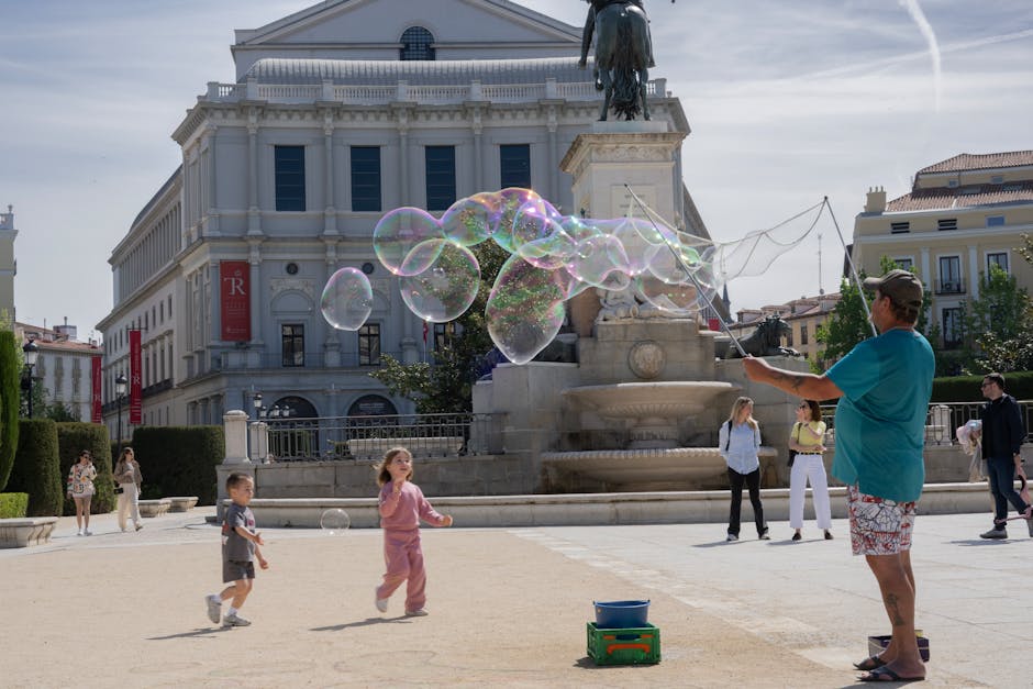 Family with children playing in a Madrid park near Teatro Real