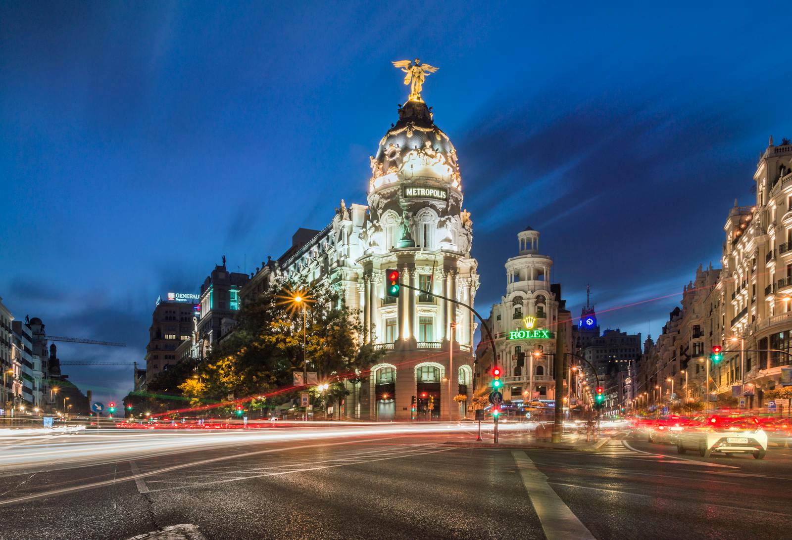 Metropolis Building on Gran Via at night with light trails