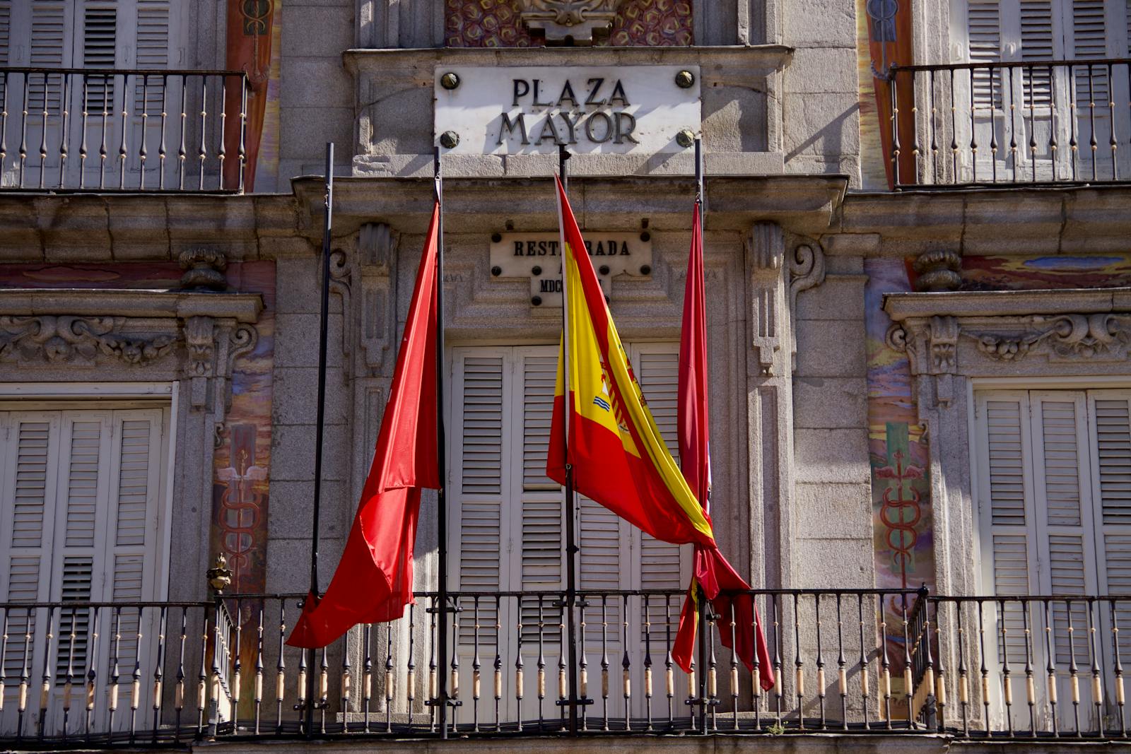 Plaza Mayor facade with flags in Madrid Centro neighborhood