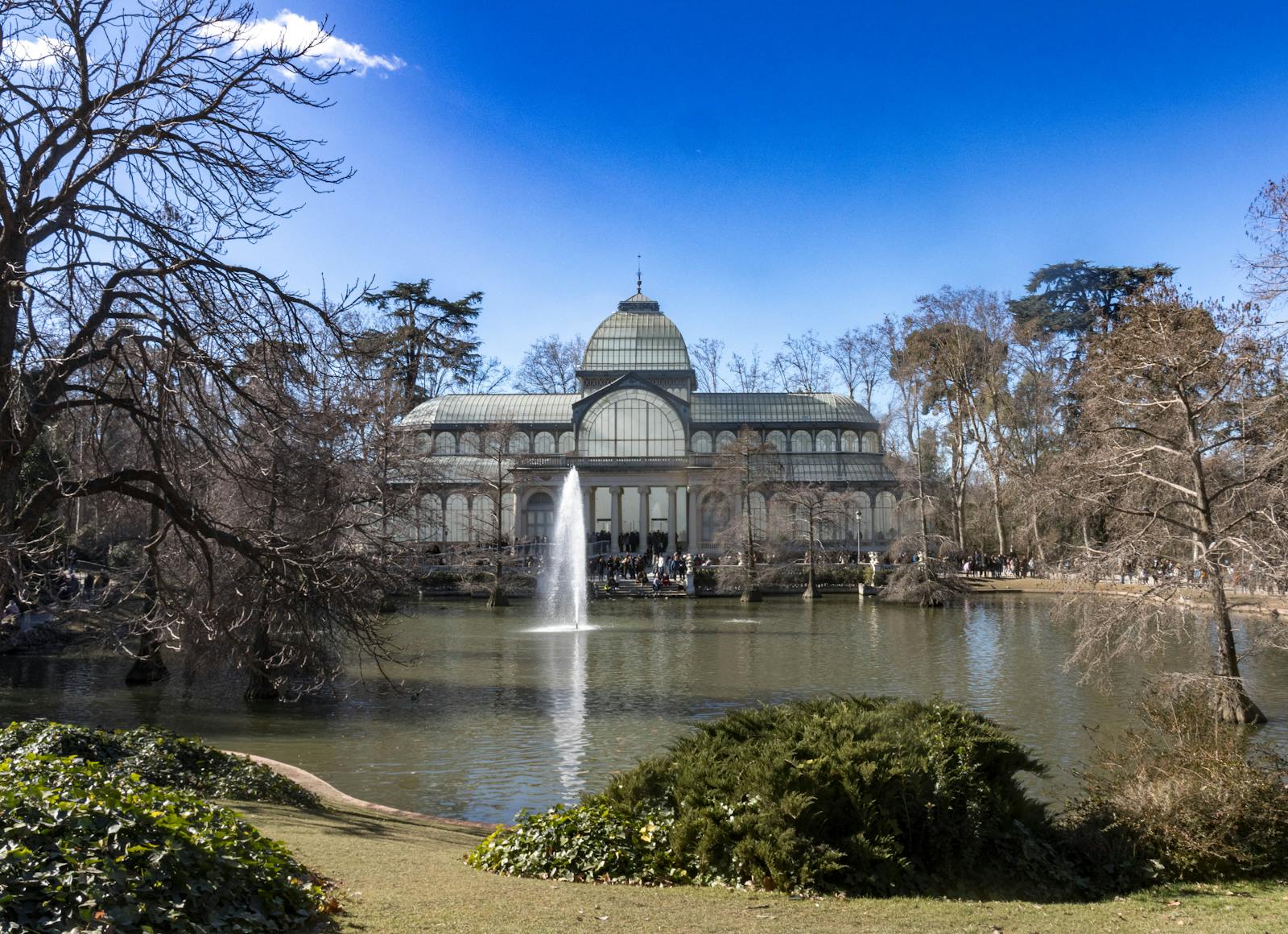 Crystal Palace in Retiro Park Madrid reflected in pond