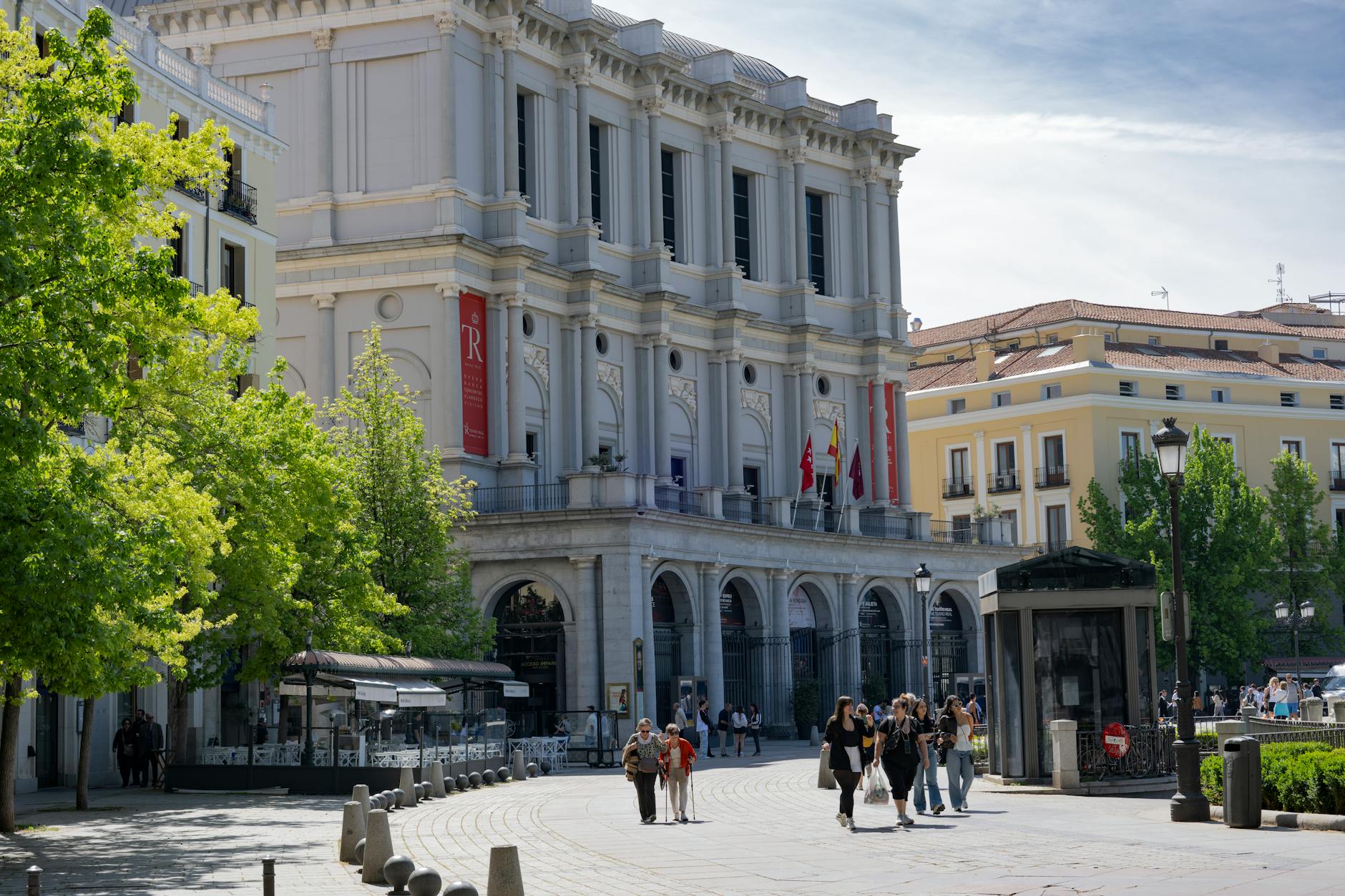 Pedestrians walking through a Madrid street scene
