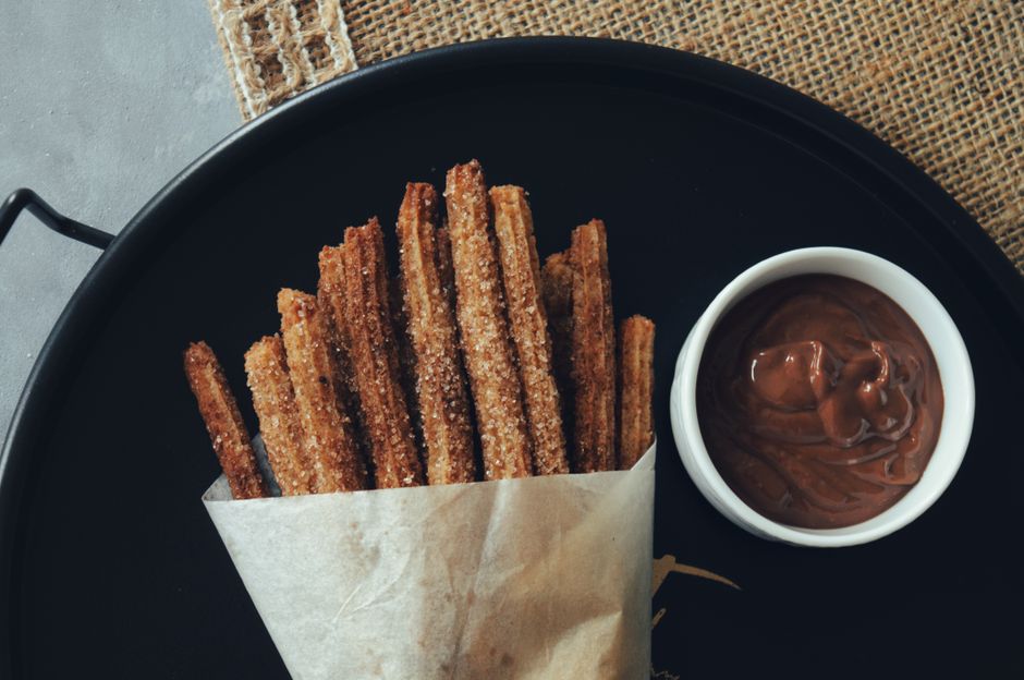 Best Churrerías Madrid Chocolate Churros: Top 8 Picks 2026 4 Fresh churros with thick chocolate dipping sauce at a Madrid churrería