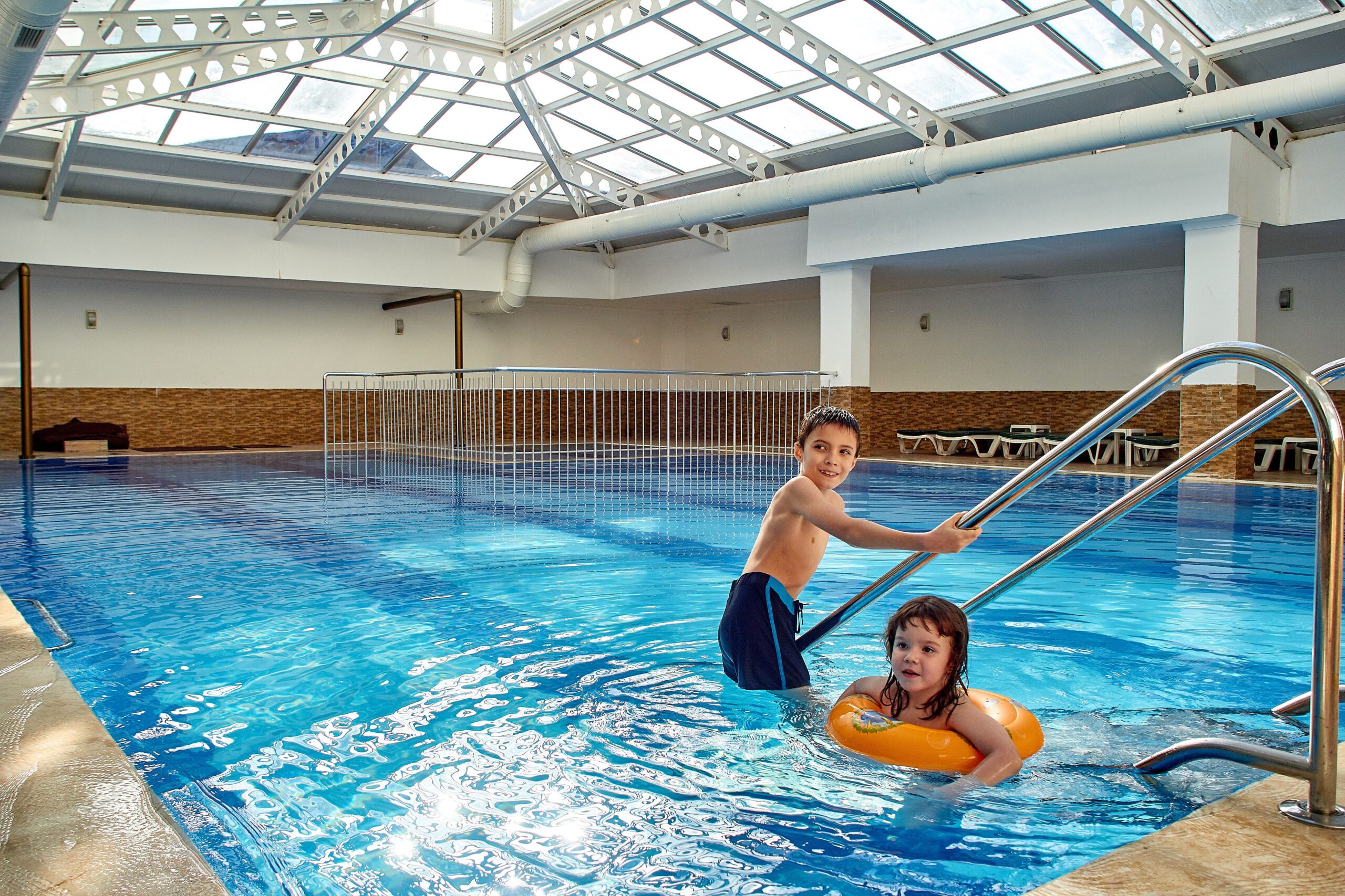 Family Hotels in Madrid: Top Picks for 2026 4 Children playing in a hotel indoor swimming pool — family friendly hotels Madrid