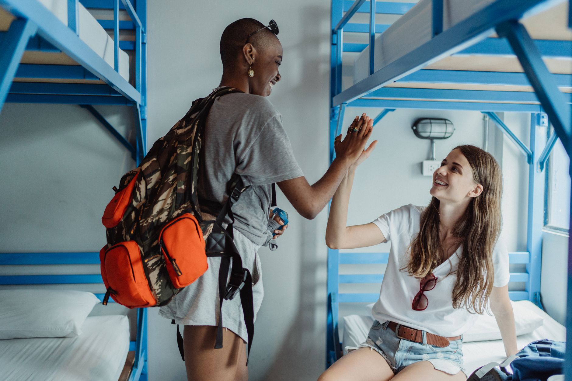 Hostel common room in Madrid with travellers relaxing on sofas