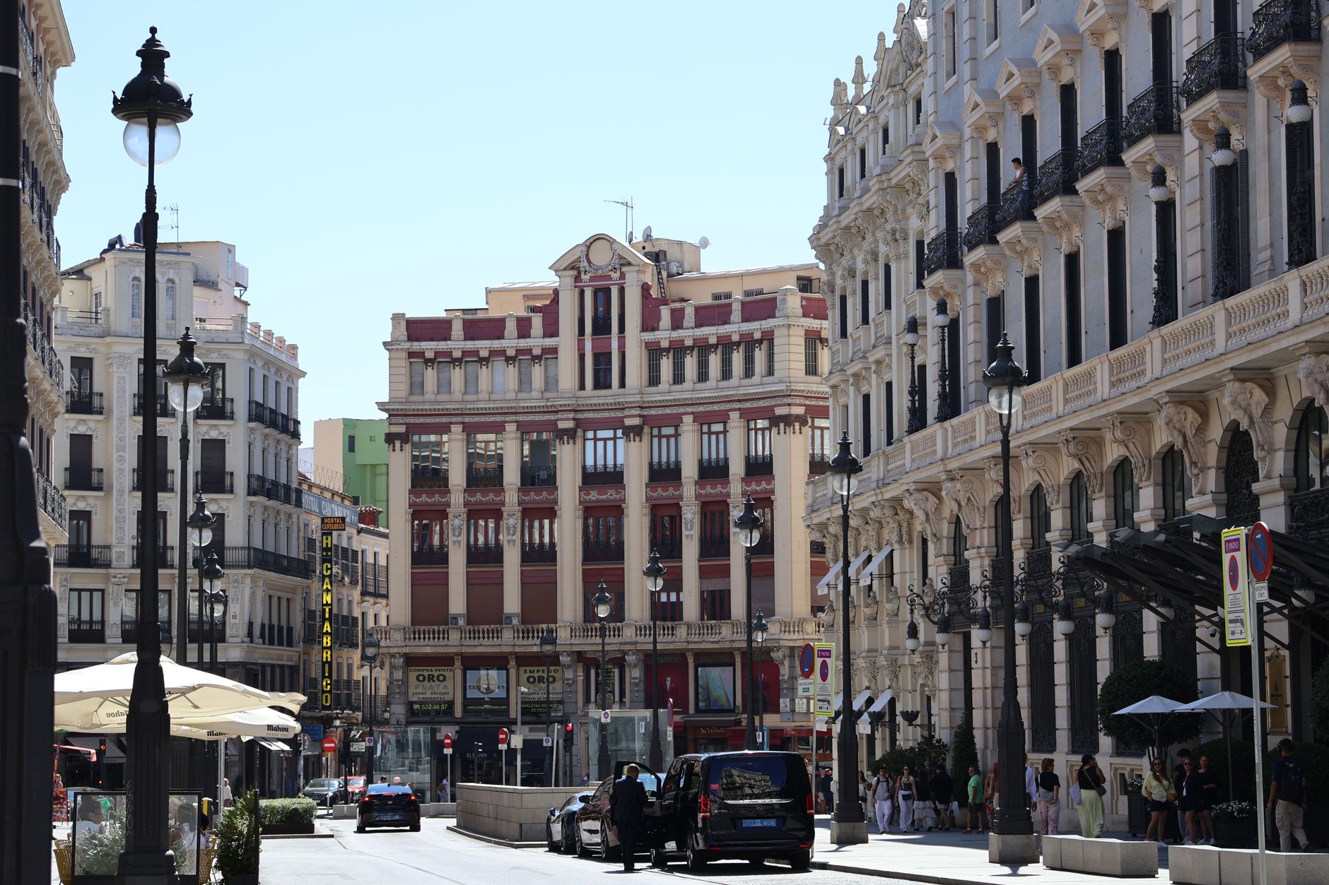 Cheap Hotels in Madrid: Best Value Options Under €100 (2026) 4 Madrid street terrace cafe with locals enjoying coffee outside